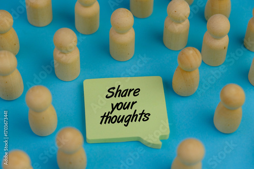 Share Your Thoughts text message on sticky note with surrounded by wooden toys on blue background