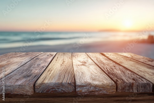 Wooden table top overlooking a beach at sunset