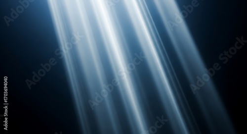 Dramatic Blue Light Rays Shining Down Against Dark Background beams