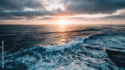 Majestic Sunset Over Ocean Waves with Dramatic Clouds and Tranquil Sky Reflections at Dusk