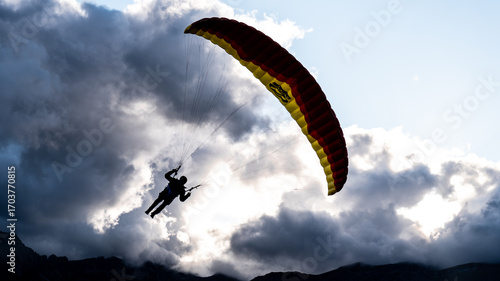 A pilot flying a speedglider in sunset clouds