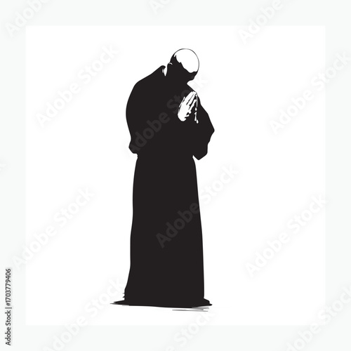 silhouette of a priest praying