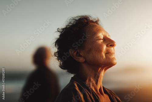 elderly woman gazes upward her expression softening as warm tears evoke sense of relief
