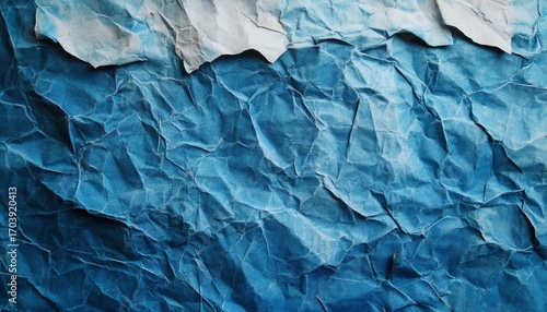 Wallpaper Mural This illustration shows a close-up view of a sheet of crumpled blue paper with a lighter blue and white section at the top. Torontodigital.ca