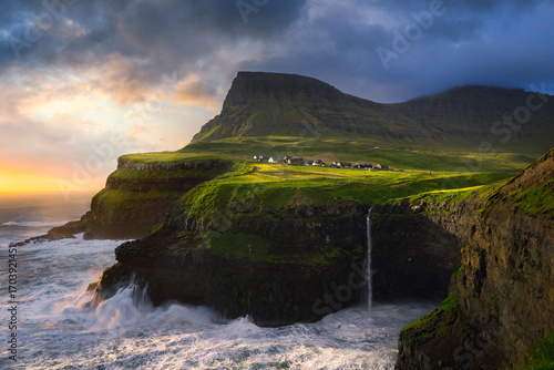 Múlafossur Waterfall during sunset with Gasadalur in frame