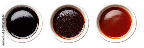 Three small white bowls filled with different sauces