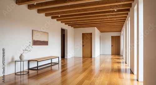 Bright interior space featuring wood flooring and exposed wood beams