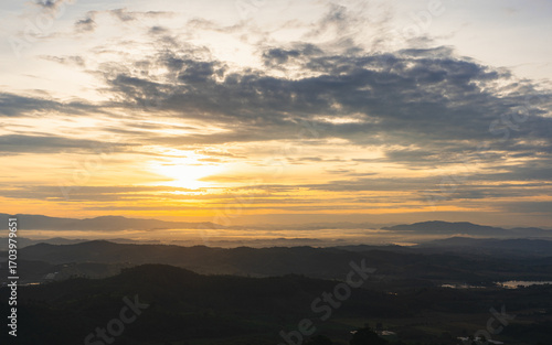 The sea of ​​mist in the morning and the sun is rising and the view of the beautiful mountains and landscape in Thailand.
