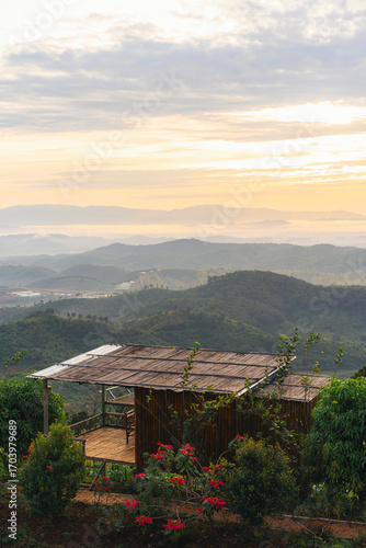 Wooden house located on the top of a mountain and overlooking the sunset with beautiful mountain views and scenery in Thailand.
