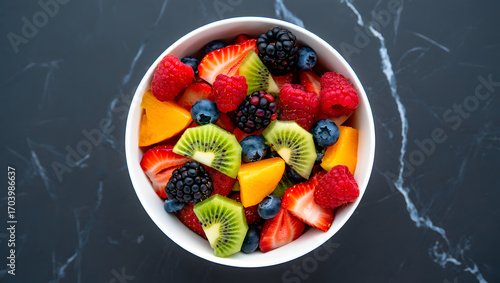 Vibrant fresh fruit salad in a white bowl top down view healthy food photography delicious refreshing meal