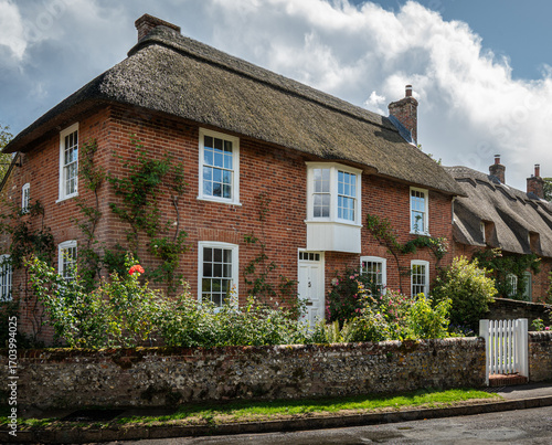 Traditional English village with thatched cottages.