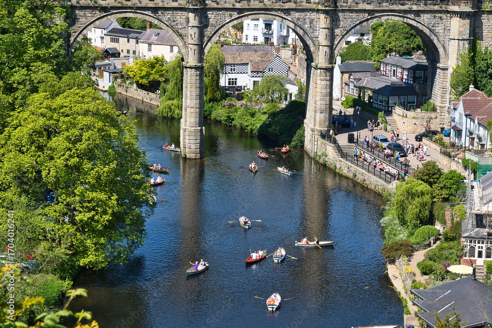 Fototapeta premium River with Boats Under Stone Bridge with Town in Knaresborough, UK.