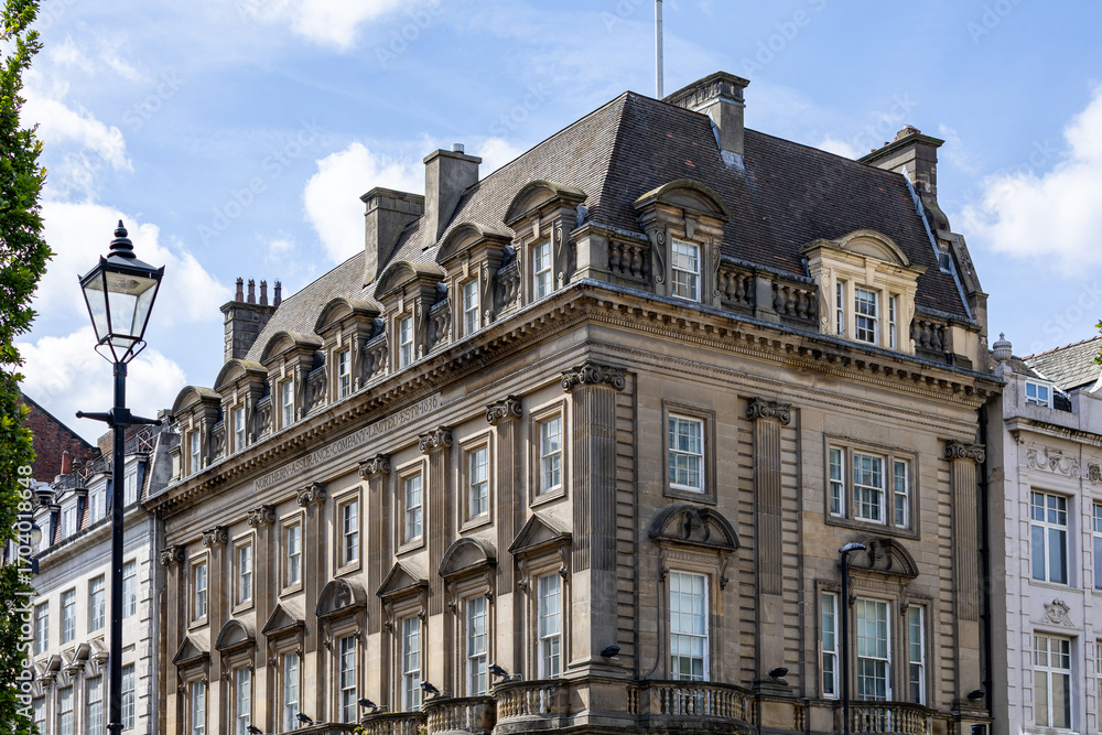 Fototapeta premium Stone Building with Dormer Windows and Lamppost in Newcastle upon Tyne, UK.