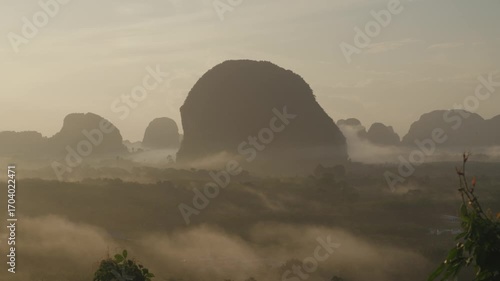 Sunrise view with mist over mountains and forest at Din Daeng Doi, Krabi, Thailand, creating a serene and dramatic natural landscape.