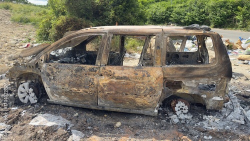 Fotografie Burned Minivan on Dirt Road