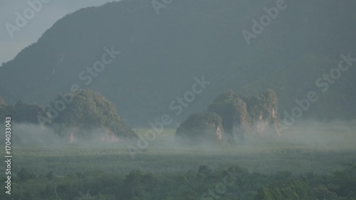 Sunrise view with mist over mountains and forest at Din Daeng Doi, Krabi, Thailand, creating a serene and dramatic natural landscape.