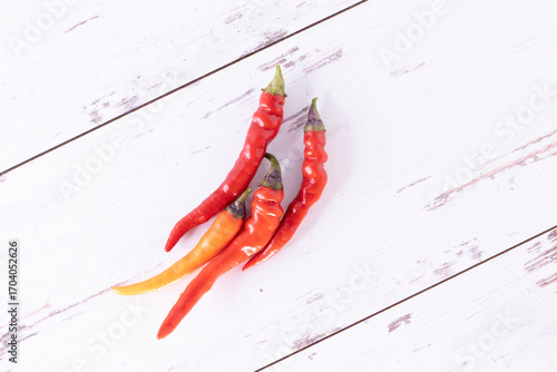Fresh hot chili peppers on white-washed distressed wood surface
