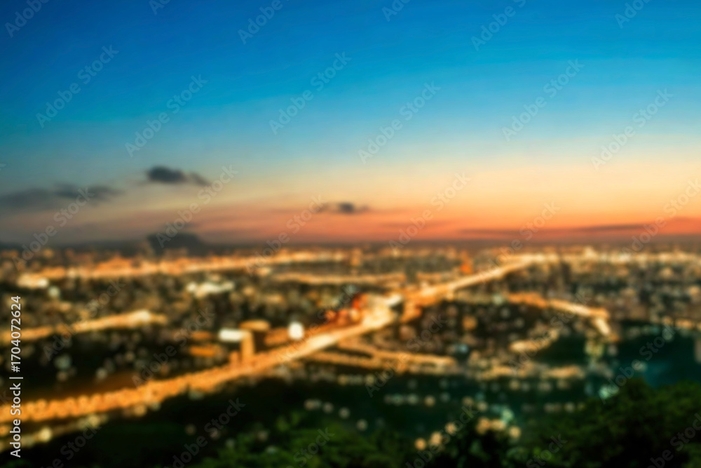 Naklejka premium The lights of the night city. Blurred background. Lanterns on the street. big city lights in the twilight evening with blurring. Colorful circles of light abstract. circular bokeh on blue horizon.
