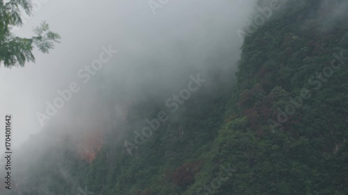 Sunrise view with mist over mountains and forest at Din Daeng Doi, Krabi, Thailand, creating a serene and dramatic natural landscape.