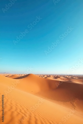 Serene Moroccan desert landscape, vast blue sky, sand dune, day, stock photo