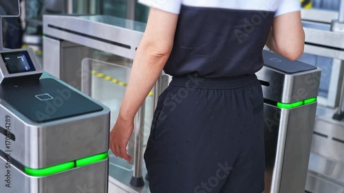 Woman holding mobile phone scanning enters checkpoint, slow motion video