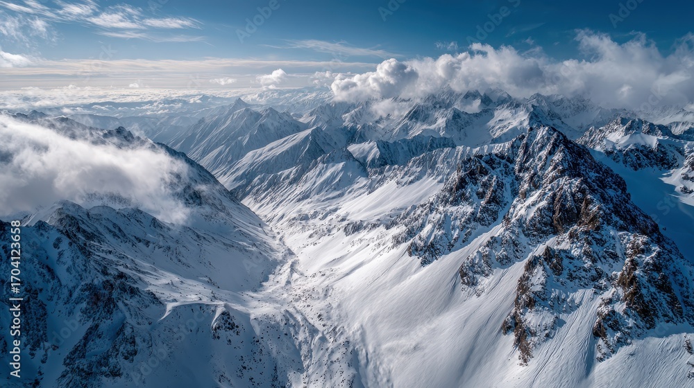 Fototapeta premium Majestic Aerial View of Snow-Capped Mountain Peaks in Clear Sky