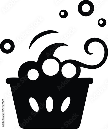 Black silhouette of a laundry basket overflowing with bubbles and soap suds on a white background