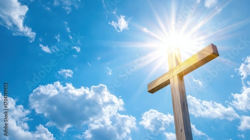 Wooden cross with sun rays and blue sky