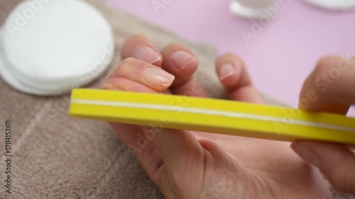 Nail care and moisturizing hand cream routine for women's manicured hands