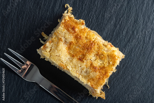 Moist layered apple semolina pie with crispy golden topping - top view.