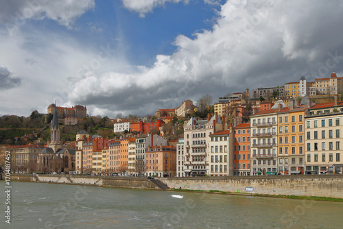 Houses and church on river embankment. Lyon, France