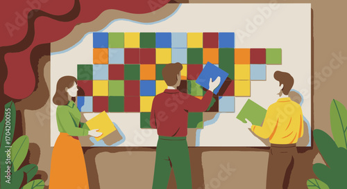 Three colleagues collaborating on a project, arranging colorful tiles on a large board in a creative office setting.