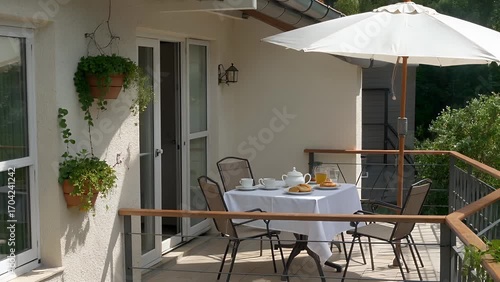 Illuminated Elevated Outdoor Patio Space Featuring Dining Set for Morning Meals