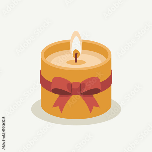 Orange candle with red ribbon and lit flame wick