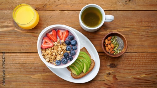 A Colorful and Nutritious Breakfast Spread Featuring Fresh Fruits, Granola, Avocado Toast, and Healthy Beverages on a Rustic Wooden Table