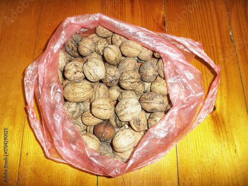 Bag of walnuts on a wooden table
