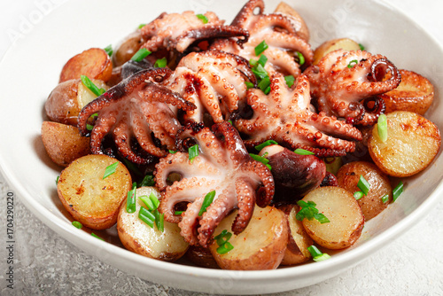 baby grilled octopus with golden baked potatoes and fresh herbs, Maltese cuisine, homemade, no people,
