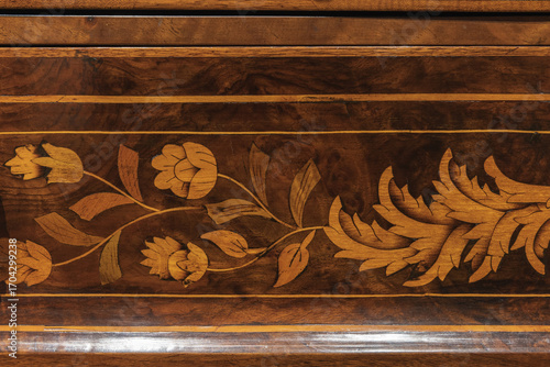 Принти на полотні A close-up view of a detailed floral inlay pattern on a wooden furniture