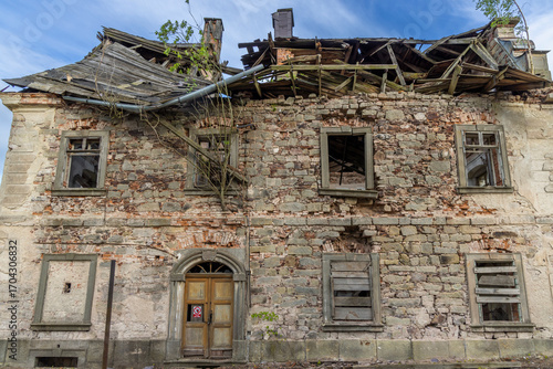 Ruined house with collapsed roof and broken windows in Sonov, Czechia