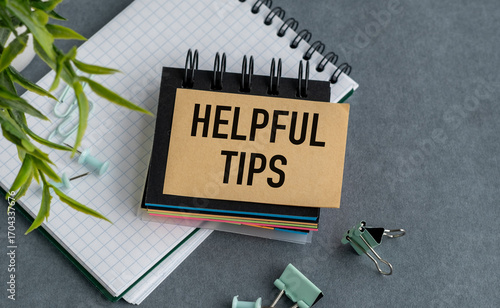 A notebook with a sign that says Helpful Tips on top of it
