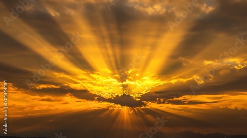 Golden sunset sky with crepuscular rays