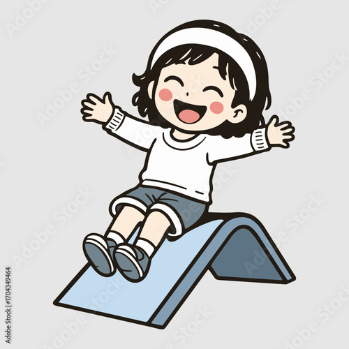 Joyful child with playful delight sliding on a metal slide