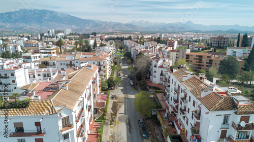 Stock aerial image of an urban city neighborhood with residential buildings, streets and rooftops, created as a resource for real estate, housing and architecture projects. Not a specific location.