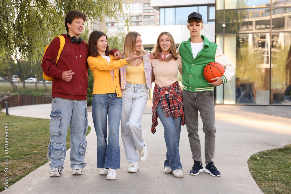 Fototapeta premium Group of teenagers walking on city street