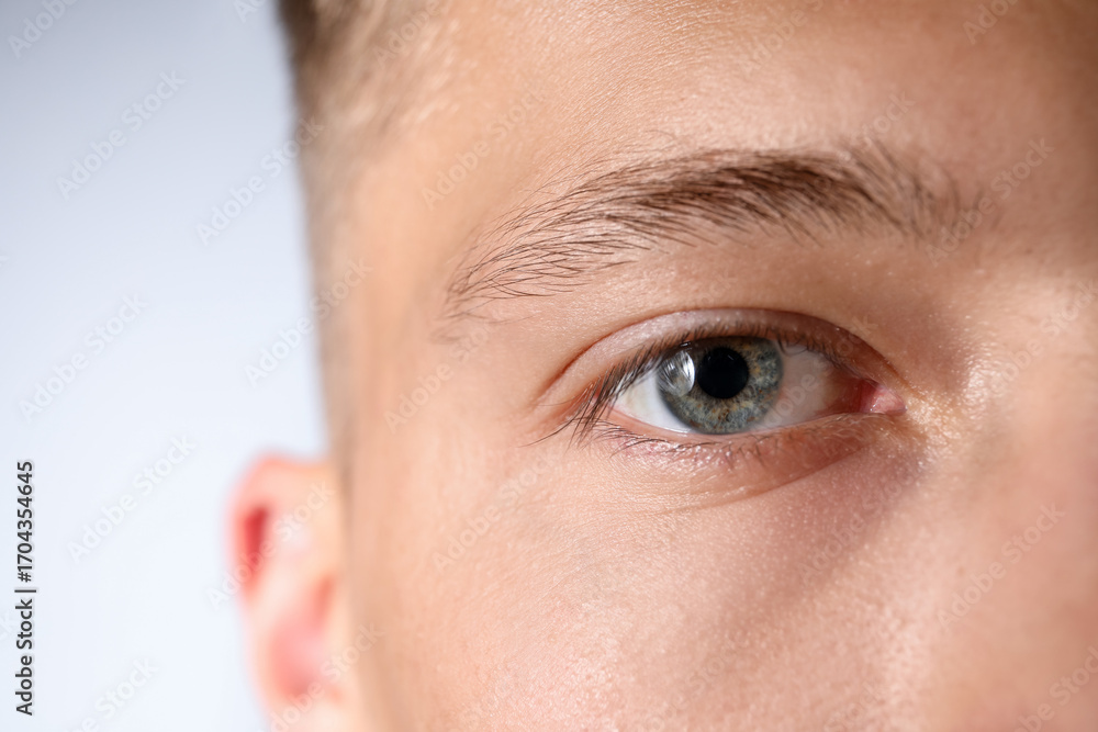 Fototapeta premium Man with beautiful eyes on light grey background, closeup