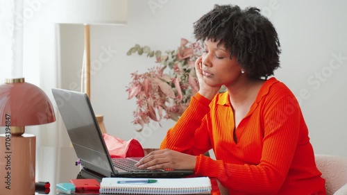 A young woman is deeply focused and somewhat frustrated while working on her laptop, illustrating the challenges and stress that students often face during their studies and personal endeavors in life