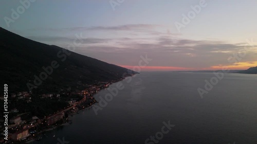 Aerial Sunset Over Lake Garda: Drone Flight from Porto di Brenzone, Brenzone sul Garda, Italy
