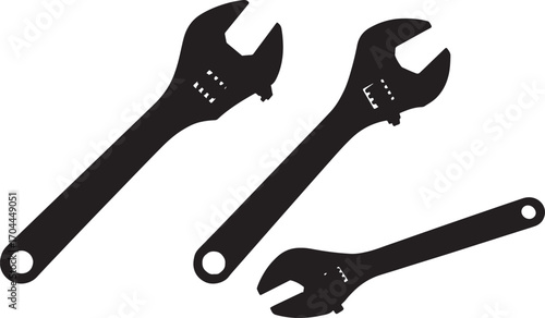 Three adjustable wrenches in a dark silhouette on a white background
