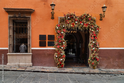 Festive storefront with garland and mannequins in historic center of San Miguel de Allende, Mexico