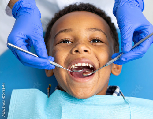 Young Boy Receiving Dental Checkup with Blue Gloves and Tools